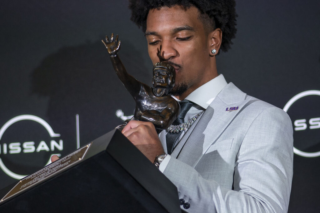 LSU quarterback Jayden Daniels kisses the Heisman Trophy during a news conference after winning the award Saturday, Dec. 9, 2023, in New York.