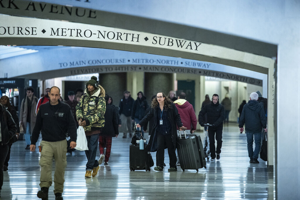 Holiday Travel Travelers walk down a hallway in Grand Central Station