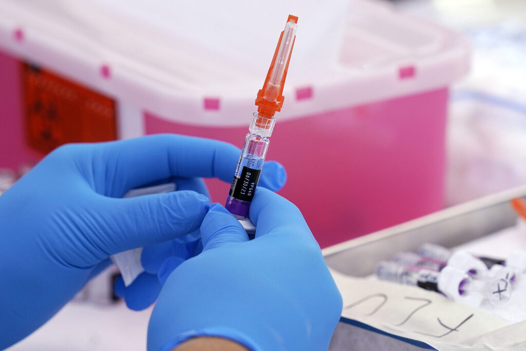 Winter Viruses An upclose view of someone holding a syringe of the flu vaccine
