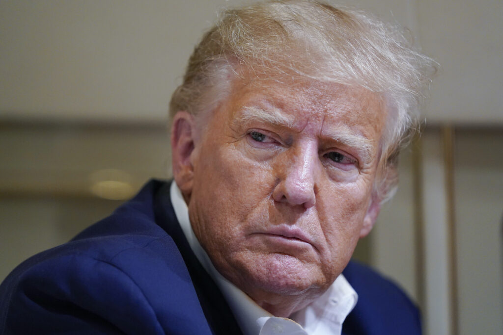 Donald Trump File photo: Former President Donald Trump listens as he speaks with reporters while in flight on his plane after a campaign rally at Waco Regional Airport, in Waco, Texas, March 25, 2023, while en route to West Palm Beach, Fla.