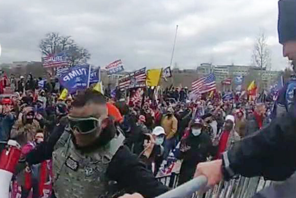 This image from video from a police-worn body camera provided by the Justice Department and contained in the statement of facts shows Samuel Lazar, bottom left, at the U.S. Capitol on Jan. 6, 2021, in Washington. Court documents unsealed this week say that a Pennsylvania man who was sentenced in secret for his role in the U.S. Capitol riot cooperated with authorities investigating the Jan. 6, 2021, attack and an unrelated case. The documents provide insight into the unusual secrecy regarding Samuel Lazar, who was released from federal custody in September after completing his sentence in his Capitol riot case. (Justice Department via AP)