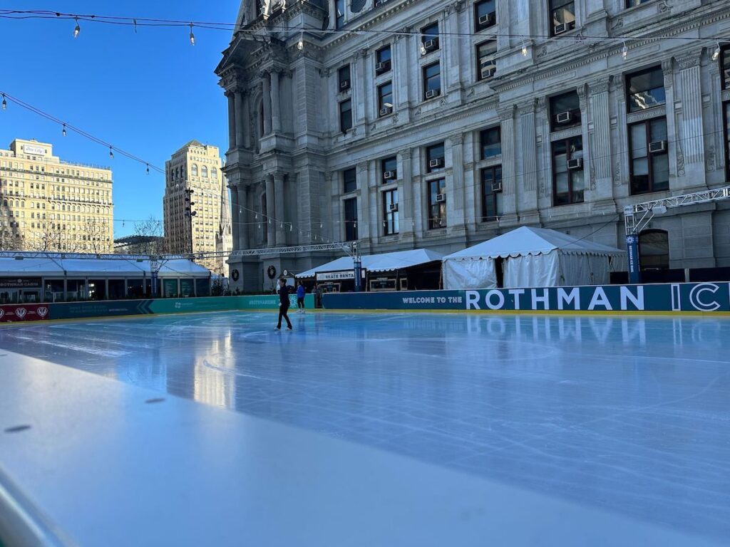 CenterCityIceRinkPhiladelphia2 A lone ice skater skates on the rink in front of City Hall