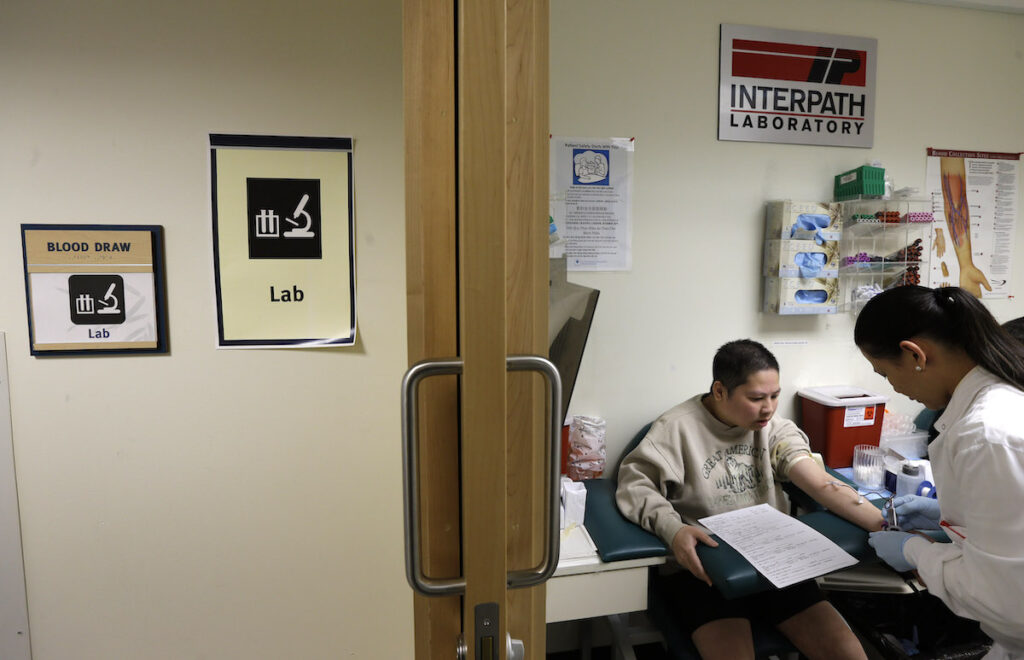 Health Overall Language Barriers Loan Truong, left, who is Vietnamese, has blood drawn by Rechyle Torio, right, a phlebotomist, Friday, March 1, 2013 at International Community. (AP Photo/Ted S. Warren)