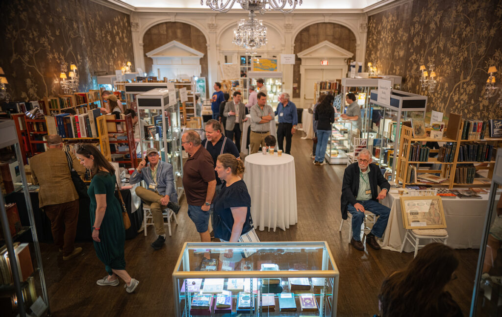 People walk around at a rare book fair
