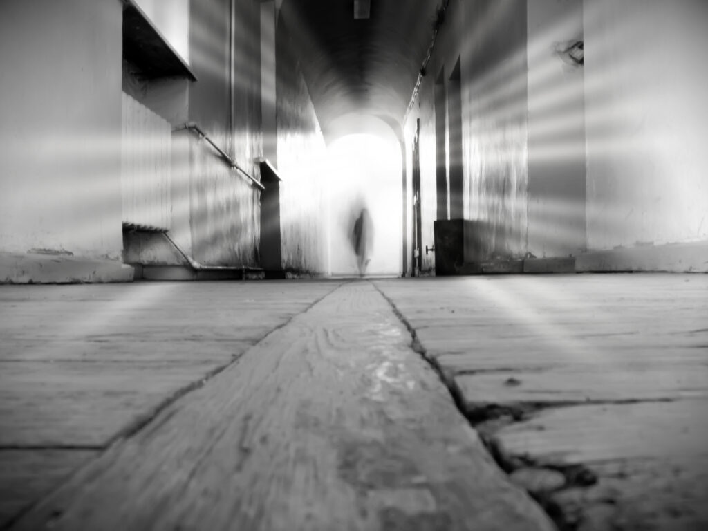 Silhouette In The Tunnel With Rays Of Light. Silhouette in the tunnel with rays of light. Concept - leaving from a life death