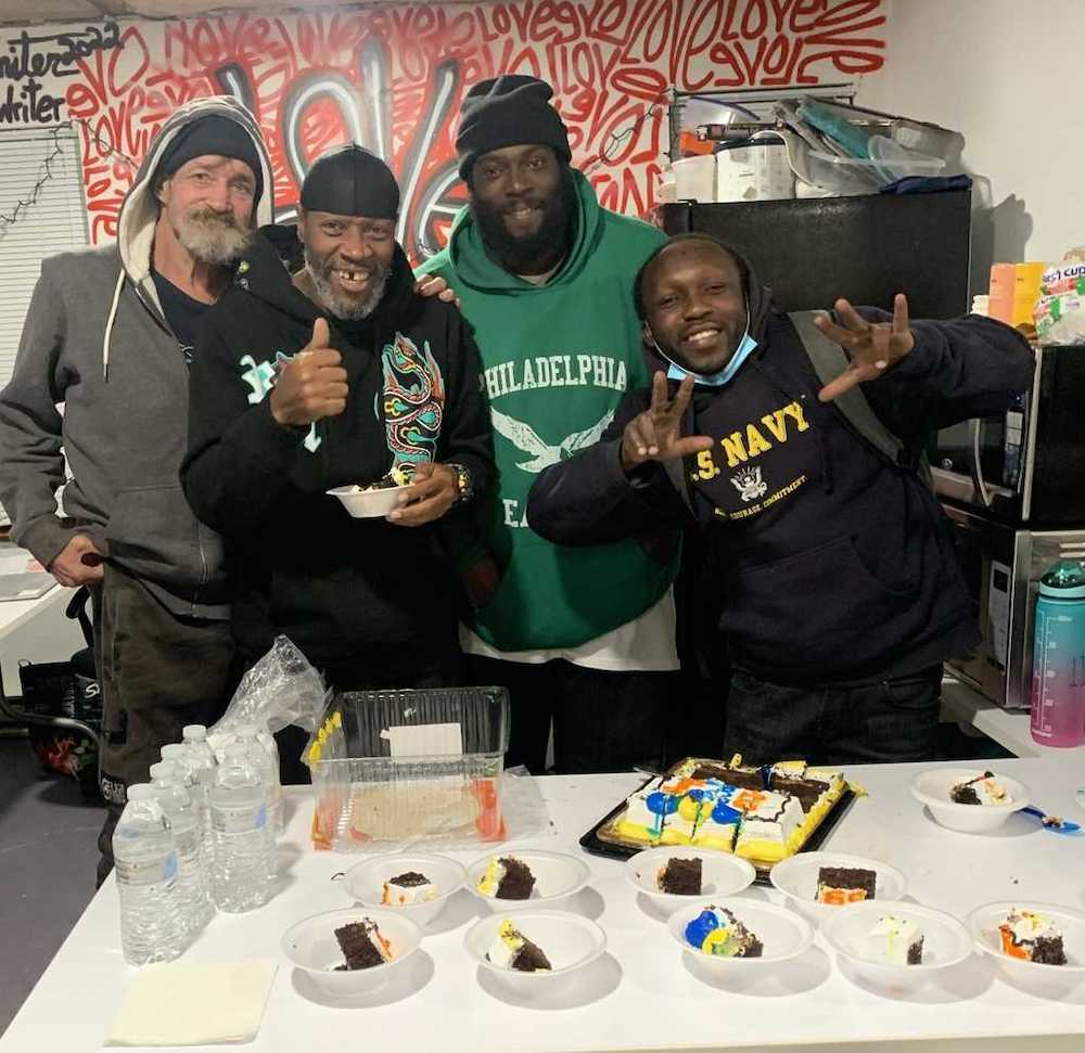 Birthday celebration at Breaking Bread Community with shelter supervisor and former resident, Jonathan Eady (center right)