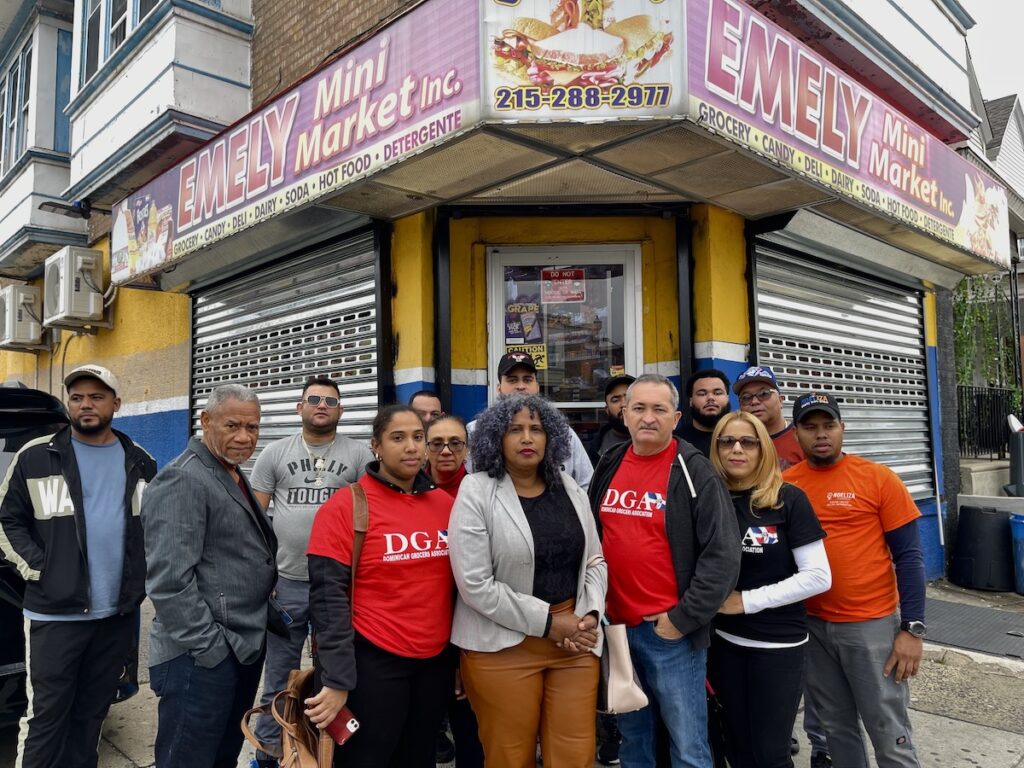 dominican-grocers-association Members of the Dominican Grocers Association stand together and pose for a photo in front of a storefront
