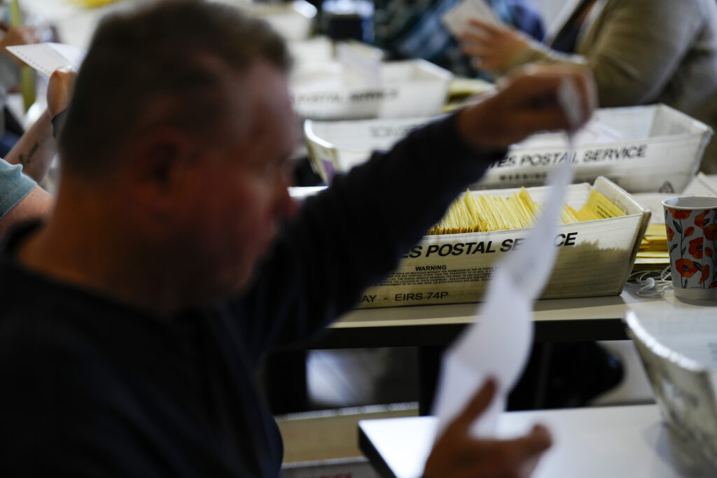 Workers sort mail ballots