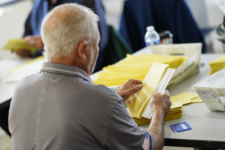 A man sorts ballots on election day
