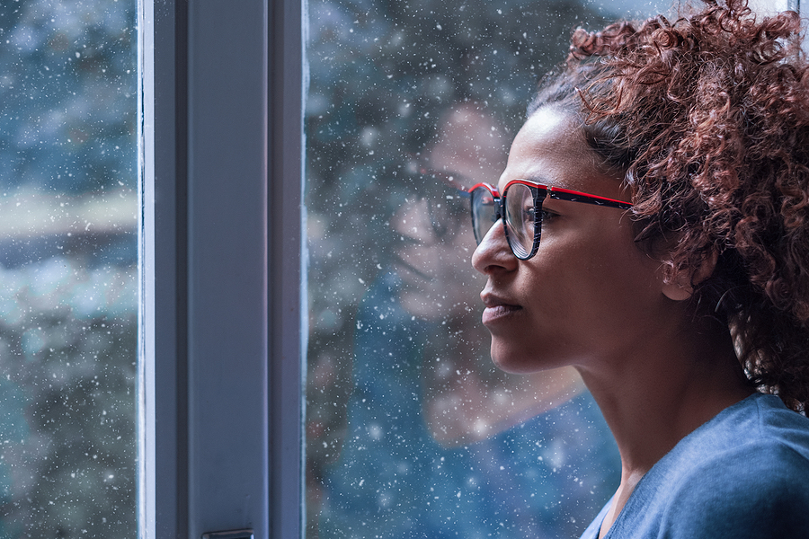 holiday blues psychologists A woman stares out the window
