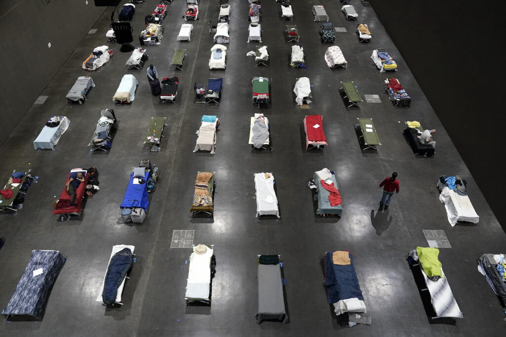 California Budget Beds fill a homeless shelter inside a convention center
