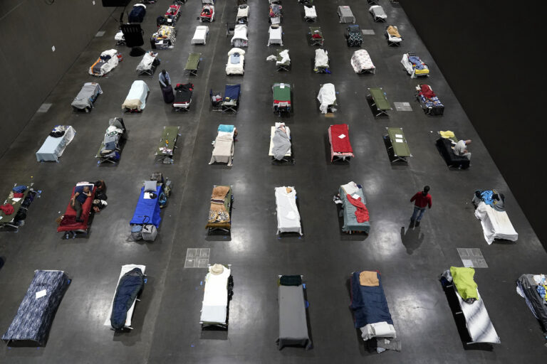 Beds fill a homeless shelter inside a convention center