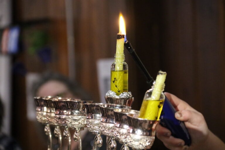 Rabbanit Dasi Fruchter lights the menorah