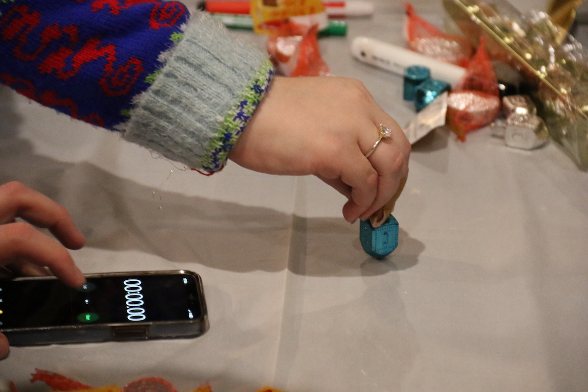 A person spins a dreidel