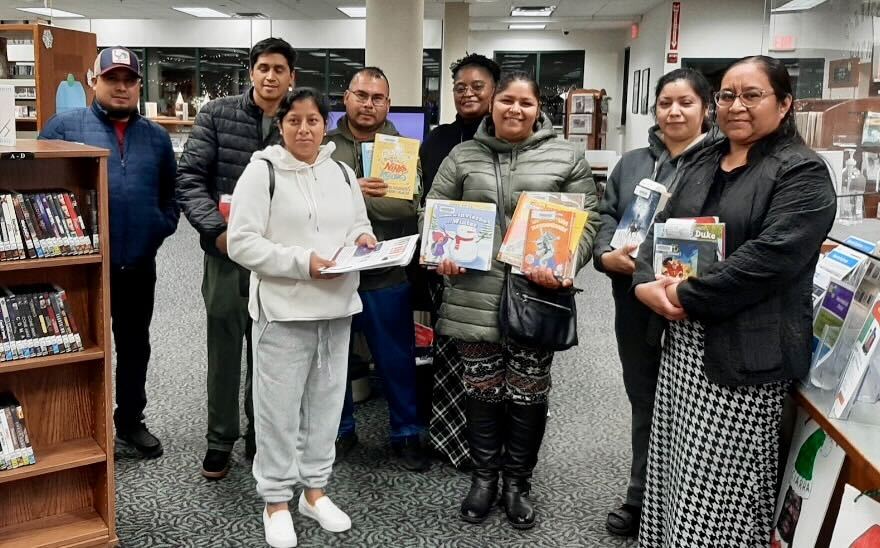 milton-elem-literacy-1 Parents pose with books in the library.