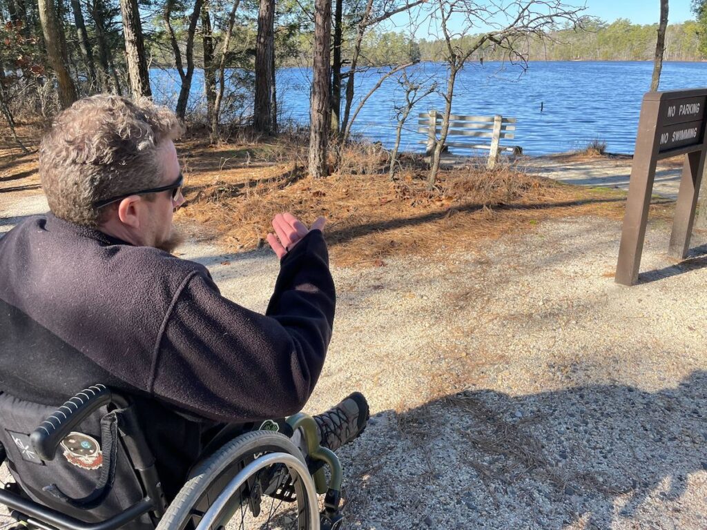 Sean Holland points towards a waterside area in the Pinelands.