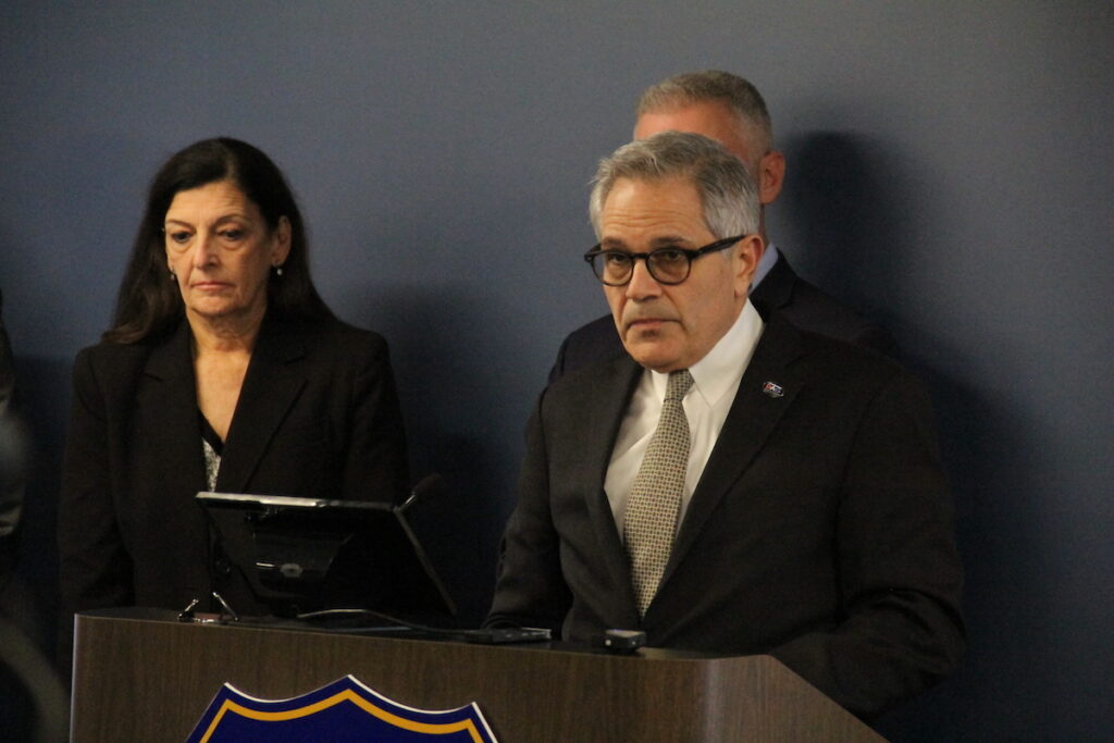 Larry Krasner speaks at a podium