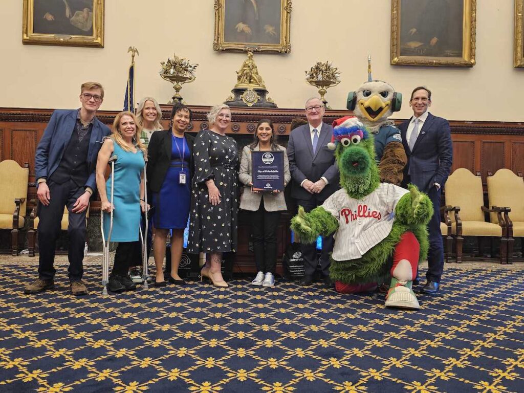 sensory-inclusive-city-2 Mayor Kenney, the Phillie Phanatic, and others pose for a photo together in City Hall.