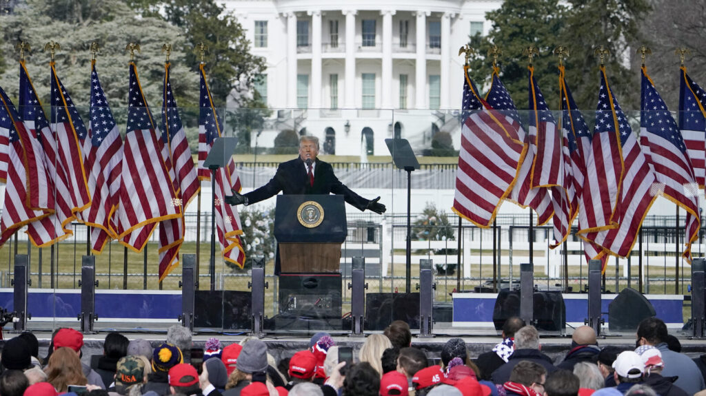 Donald Trump Trump speaks at a podium lined with U.S. flags on Jan. 6.