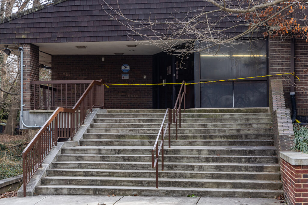 A stair case with caution tape across it at the top.
