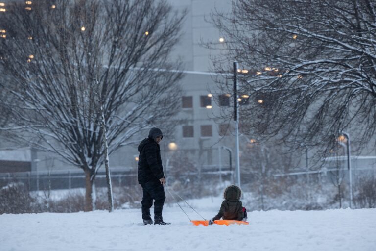 Snow falls during sunset in Philadelphia