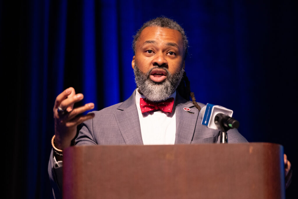 Reginald Streater, president of the Philadelphia Board of Education, speaks into a microphone at a podium