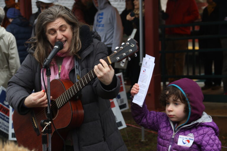 Community members across all ages made signs and showed their support for the Chestnut Hill West Regional Line during a ''rally and ride'' at the Richard Allen Lane SEPTA station on Jan. 28, 2024. (Cory Sharber/WHYY)