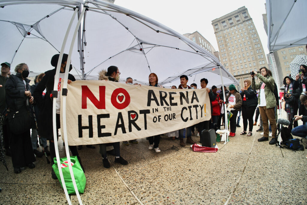 People hold up a sign that reads 