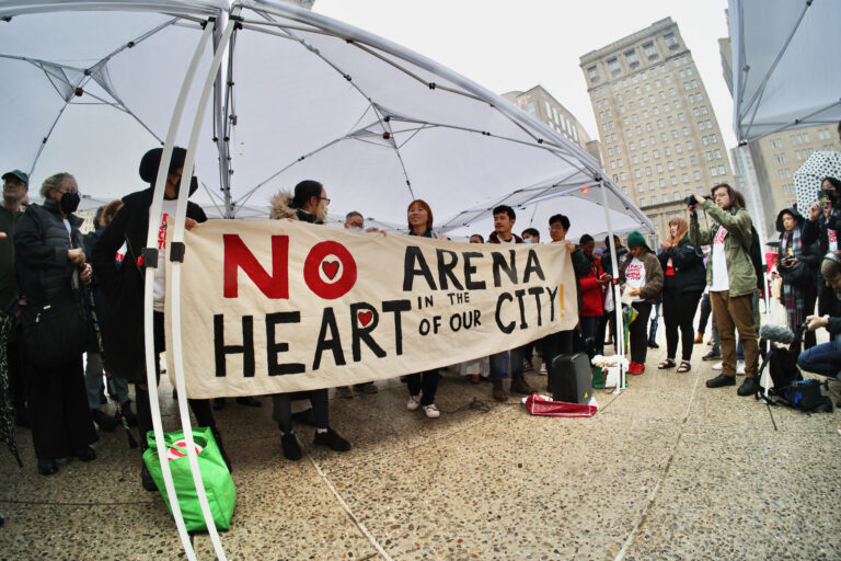 People hold up a sign that reads 