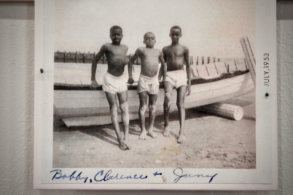 In a photo from 1953, boys puff out their chests for the photographer on Grant Street Beach. (Emma Lee/WHYY)