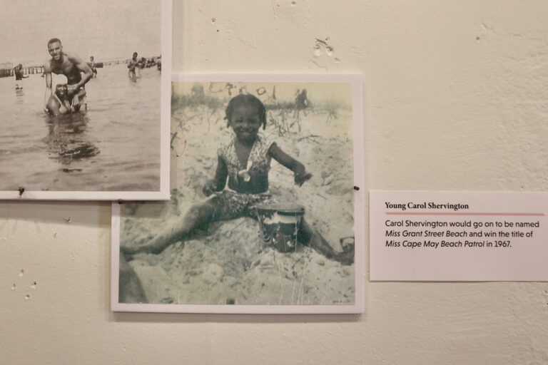 A picture of a young girl sitting in the sand with a bucket and trowel was identified by a visitor as Carol Shervington, the future Miss Grant Street Beach who went on to become Miss Cape May Beach Patrol in 1967. (Emma Lee/WHYY)
