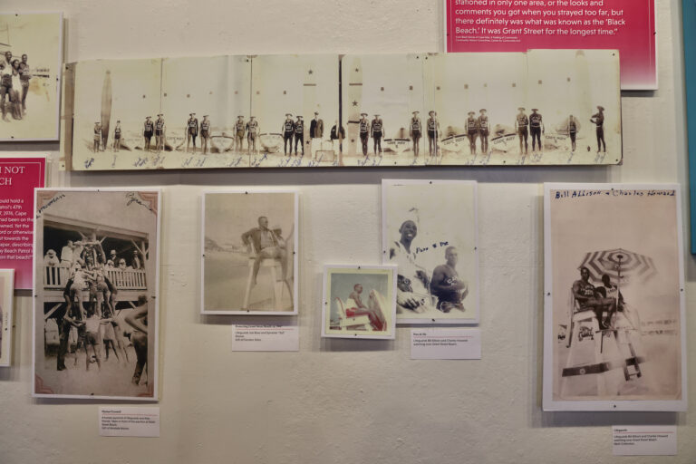 A  panoramic series of shots shows a line of Black lifeguards posing on the sand. Black beachgoers were typically guarded by Black lifeguards who would be assigned to certain beaches, typically Grant Street and Windsor Street. (Emma Lee/WHYY)