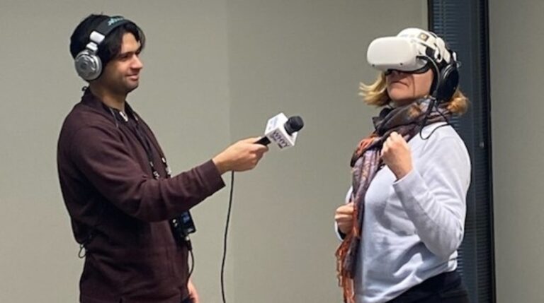 Reporter Grant Hill (left) and host
Maiken Scott of WHYY’s “The Pulse” interact with virtual reality headsets and headphones showing a quintet playing Mozart.  (Alexis Branagan, Princeton University Concerts)