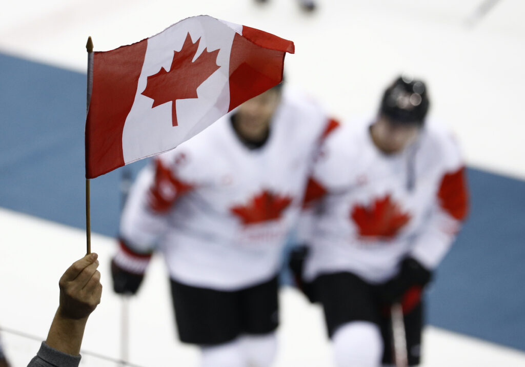 Pyeongchang Olympics Ice Hockey Men File photo: A fan waves a flag as Team Canada celebrate after the men's bronze medal hockey game against the Czech Republic at the 2018 Winter Olympics in Gangneung, South Korea, Saturday, Feb. 24, 2018