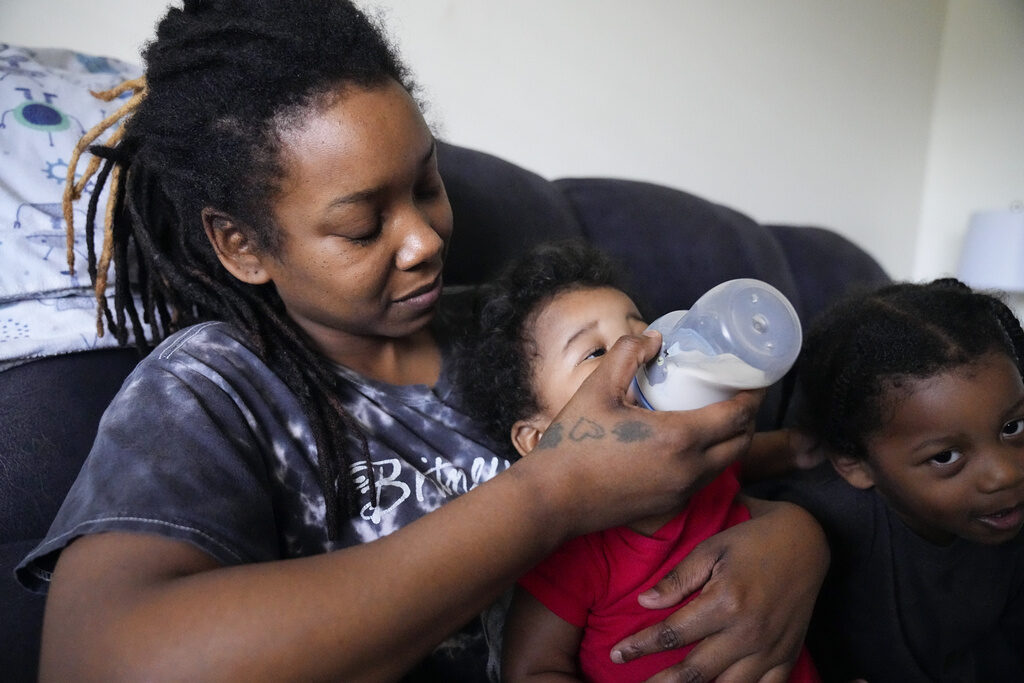 Ashley and Olivia Yancer, Oliver Tolvert Ashley Yancey feeds her 11 month-old daughter Olivia as two-year old Oliver Tolvert looks on at right
