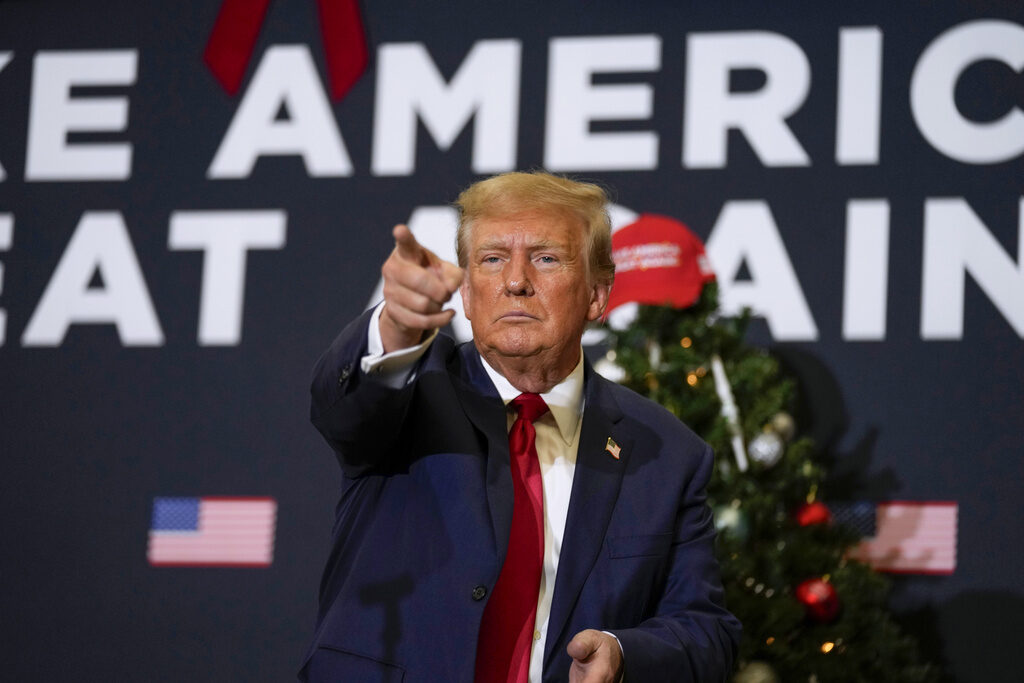 Election 2024 Trump Insurrection Amendment Former President Donald Trump points to supporters