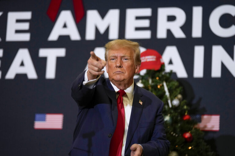 Former President Donald Trump points to supporters