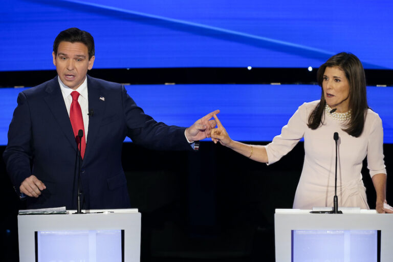 Former UN Ambassador Nikki Haley (right) and Florida Gov. Ron DeSantis (left) pointing at each other during the CNN Republican presidential debate at Drake University in Des Moines, Iowa, Wednesday, Jan. 10, 2024.