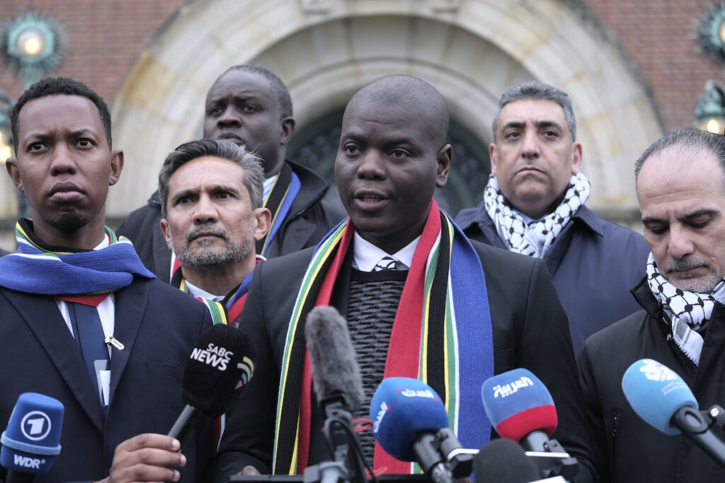 APTOPIX Israel Palestinians World Court Genocide Defense South Africa's Minister of Justice and Correctional Services Ronald Lamola (center) and Palestinian assistant Minister of Multilateral Affairs Ammar Hijazi (right) address the media outside the International Court of Justice in The Hague, Netherlands, Thursday, Jan. 11, 2024.