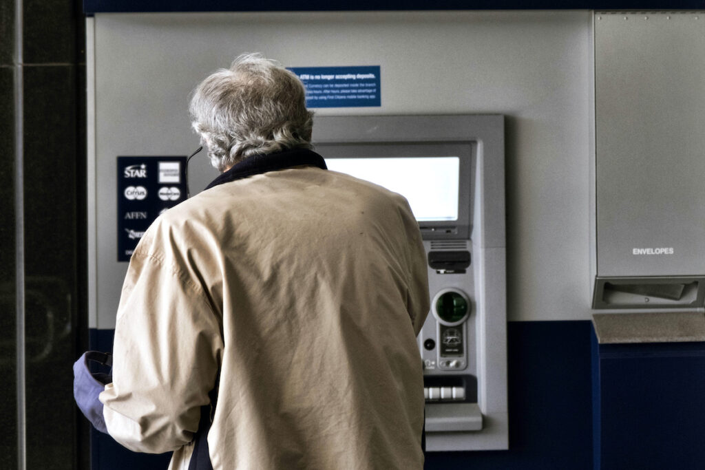 Overdraft Fees File photo: A customer makes a transaction at an automatic teller machine in Los Angeles on March 27, 2023.