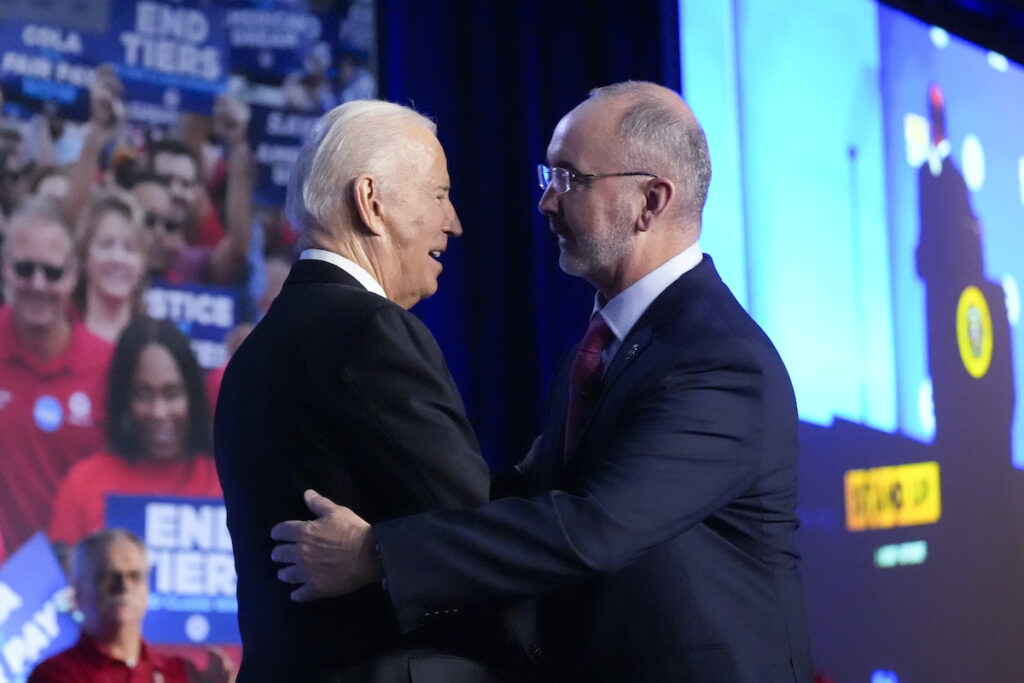 Joe Biden,Shawn Fain President Joe Biden is greeted by Shawn Fain, President of the United Auto Workers, as he arrives to speak to a United Auto Workers' political convention, Wednesday, Jan. 24, 2024, in Washington.
