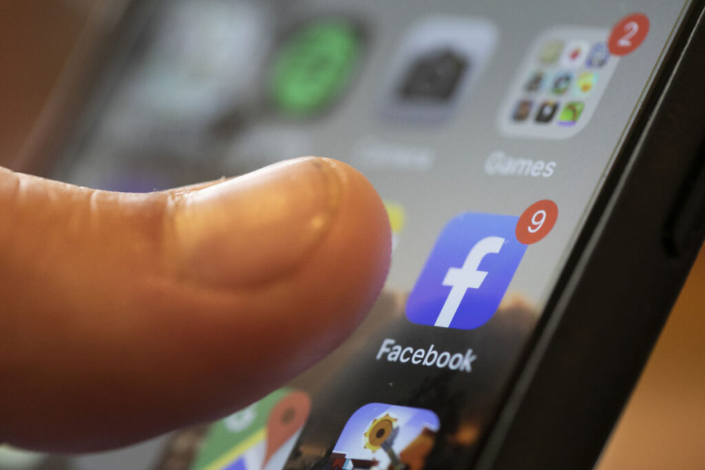 Facebook Vaccine Misinformation An iPhone displays the Facebook app. (AP Photo/Jenny Kane, File)