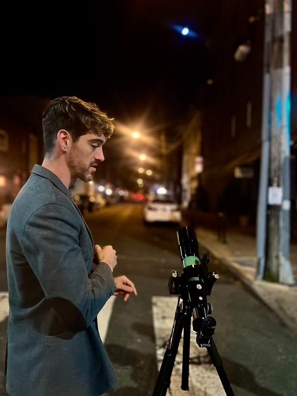 BrendanHappe Brendan Happe of Philly Moon Men with his telescope on South Street.