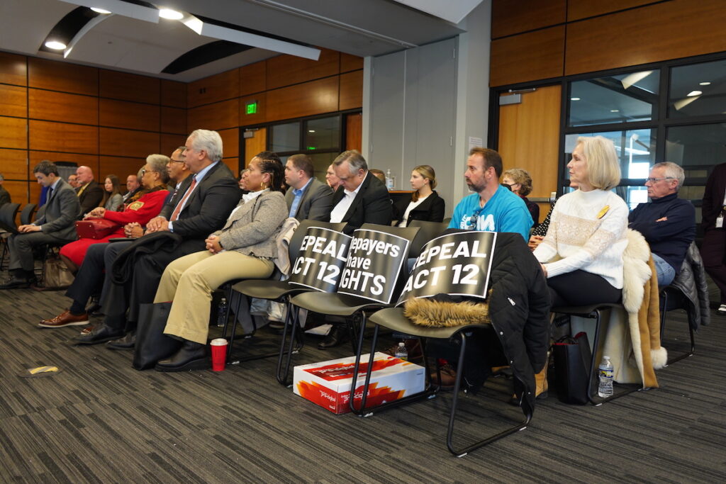 Local water officials and residents alike filled the coinference room in West Whiteland and placed signs in the first few seats calling for an appeal of Act 12 Local water officials and residents alike filled the conference room in West Whiteland and placed signs in the first few seats calling for an appeal of Act 12. (Kenny Cooper/WHYY)