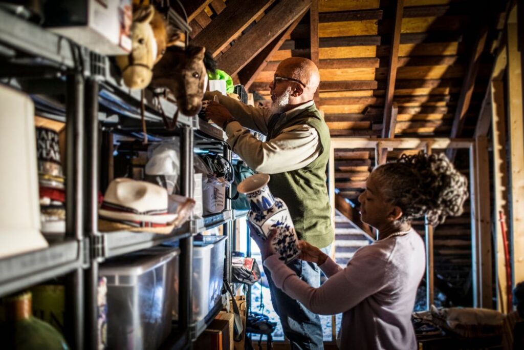 Senior couple organizing items in the home attic