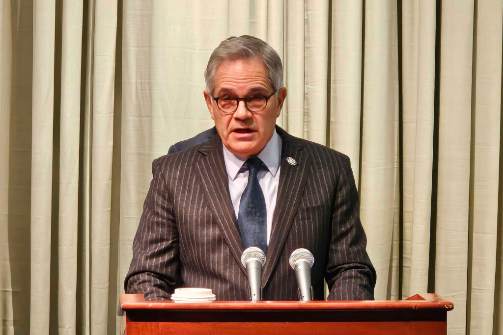 Larry Krasner speaking at a podium