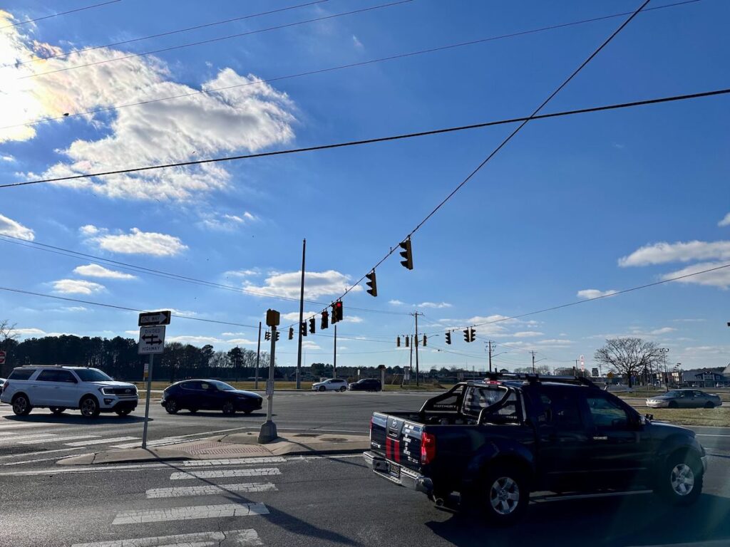 del-growth-4 Cars at the intersection of Route 113 and Route 404