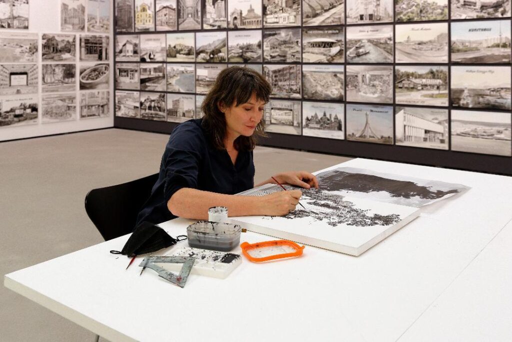 Ellen Harvey at work on a painting