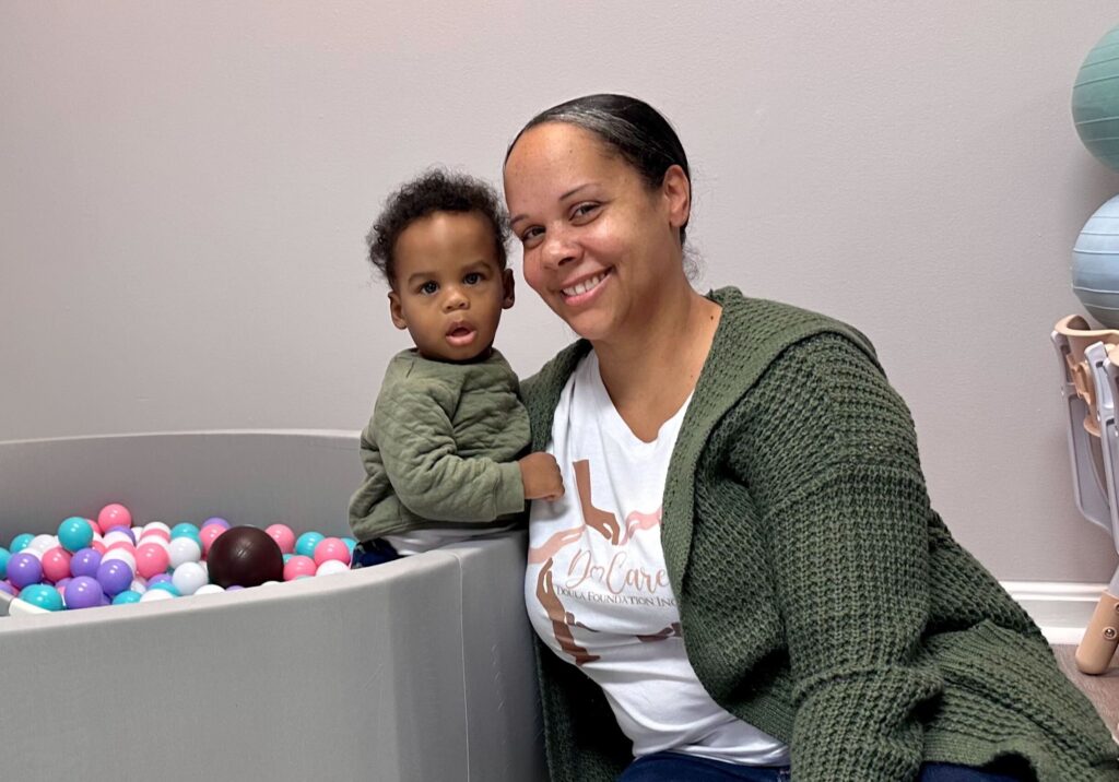 do-care-doula-j-perez-gonzalez-2024-01-07 Erica Allen, Executive Director of the Do Care Doula Foundation, engaging with her son in the children's play area. (Johnny Perez-Gonzalez/WHYY)