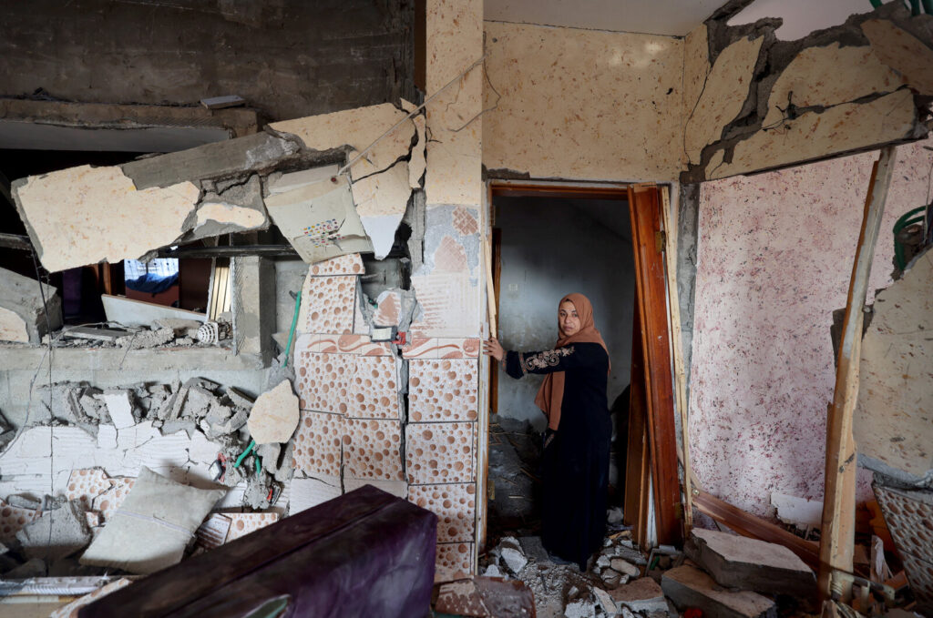 PALESTINIAN-ISRAEL-CONFLICT A woman stands in her damaged house in Rafah